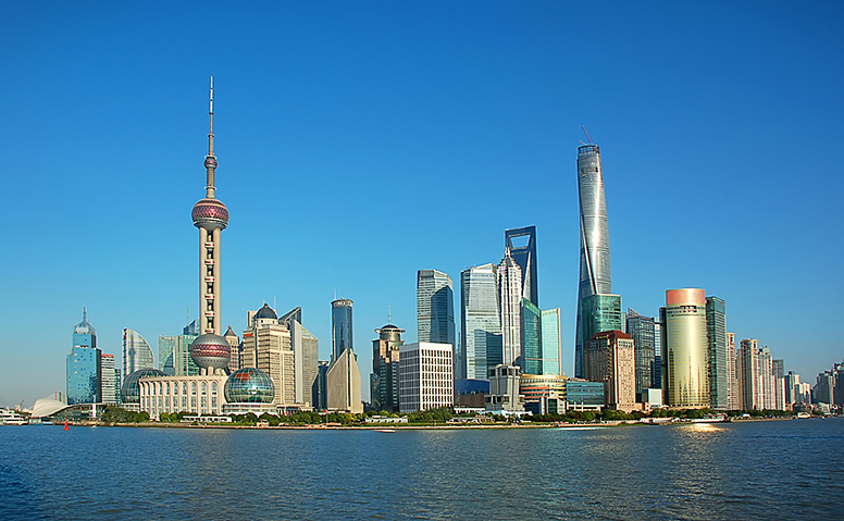 China: Shanghai skyline with skyscrapers and satellite tower under a blue sky China: Shanghai skyline with skyscrapers and satellite tower under a blue sky