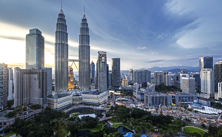 Malaysia: Panorama of Kuala Lumpur, impressive skyscrapers in front of a green park Malaysia: Panorama of Kuala Lumpur, impressive skyscrapers in front of a green park