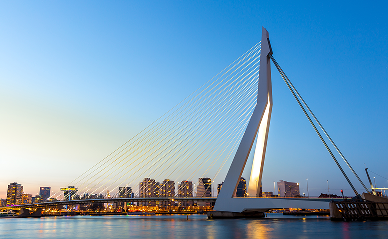 Netherlands: Rotterdam skyline at dusk, the Erasmus Bridge can be seen in the foreground Netherlands: Rotterdam skyline at dusk, the Erasmus Bridge can be seen in the foreground